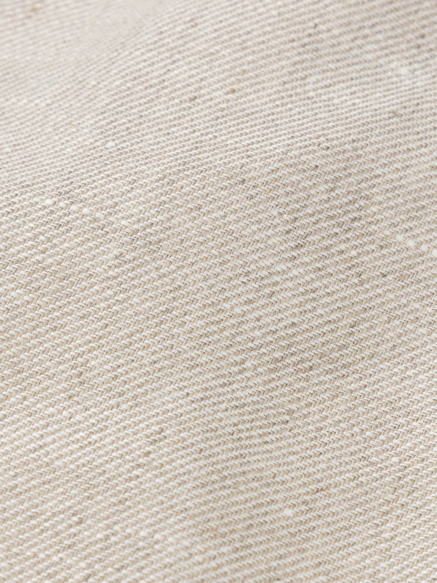 Close-up of beige Irish linen fabric showing natural weave texture of the Nehru jacket