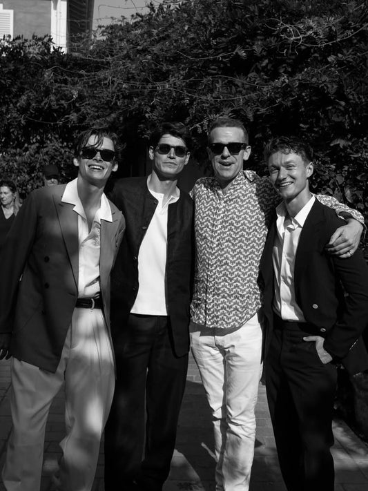 Sam Way wearing Heron's Ghyll black linen collarless suit