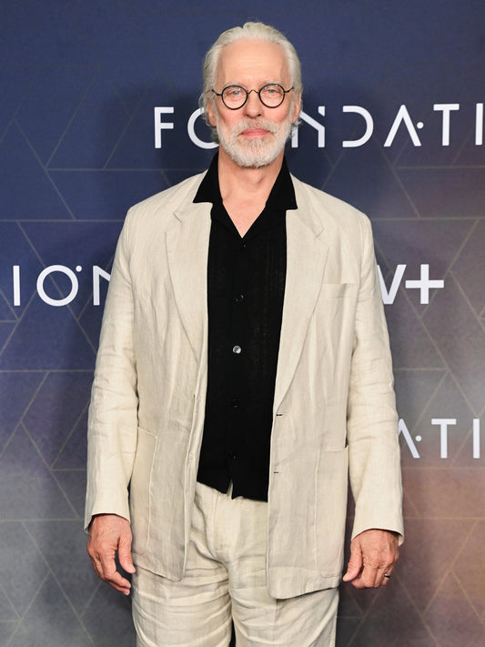 Actor Terrence Mann wearing Heron’s Ghyll beige linen suit with black shirt at the Foundation photocall in London