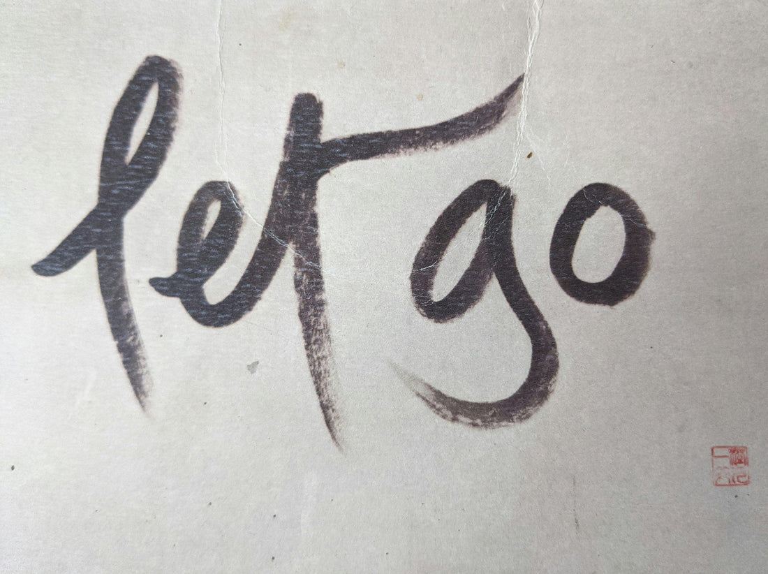 Ink painting of the words "let go"