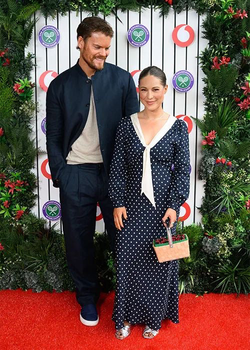 Ryan Libbey wearing Heron's Ghyll navy blue linen relaxed Nehru suit at Wimbledon with Louise Thompson.